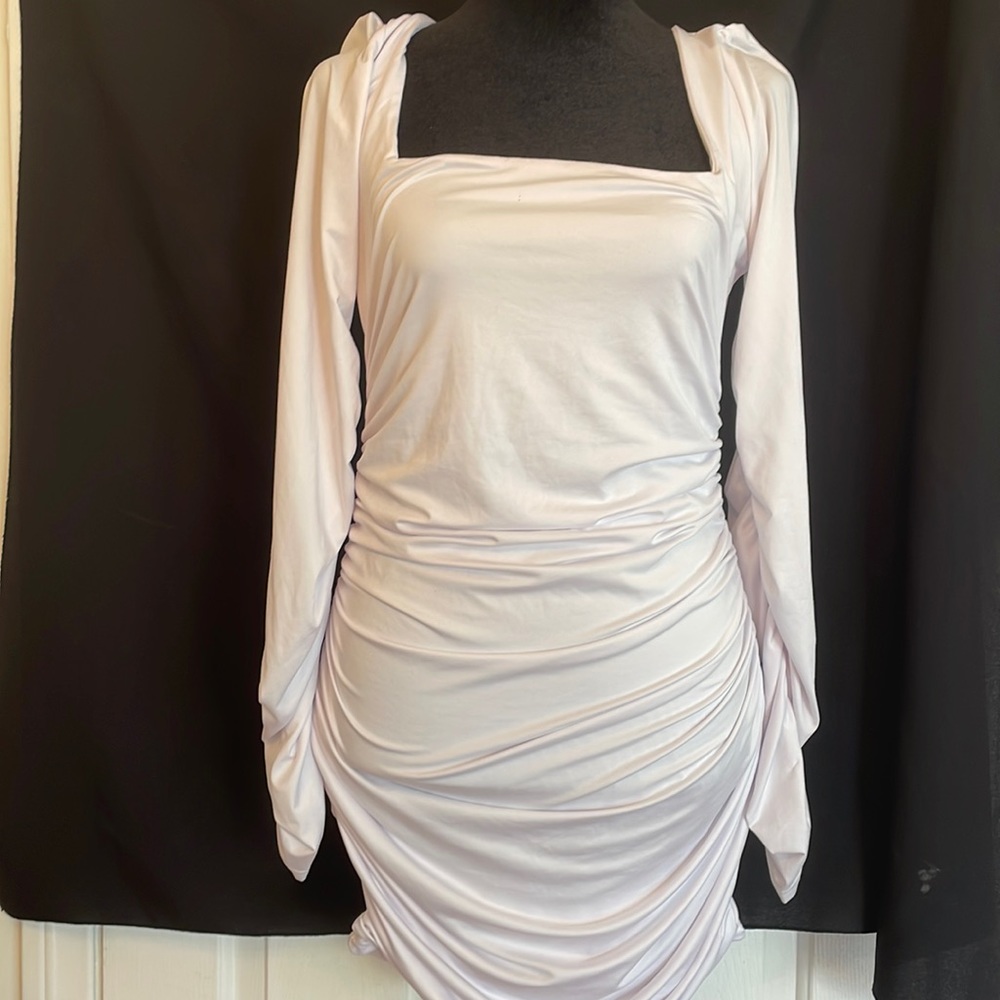 Gorgeous white dress. Has ruching on sides/butt. Gives a great figure. Sz-L